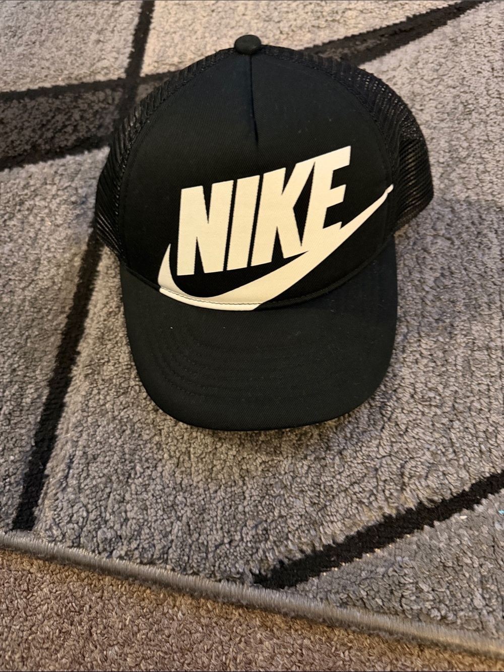 Nike Black Trucker Hat with White Swoosh Logo